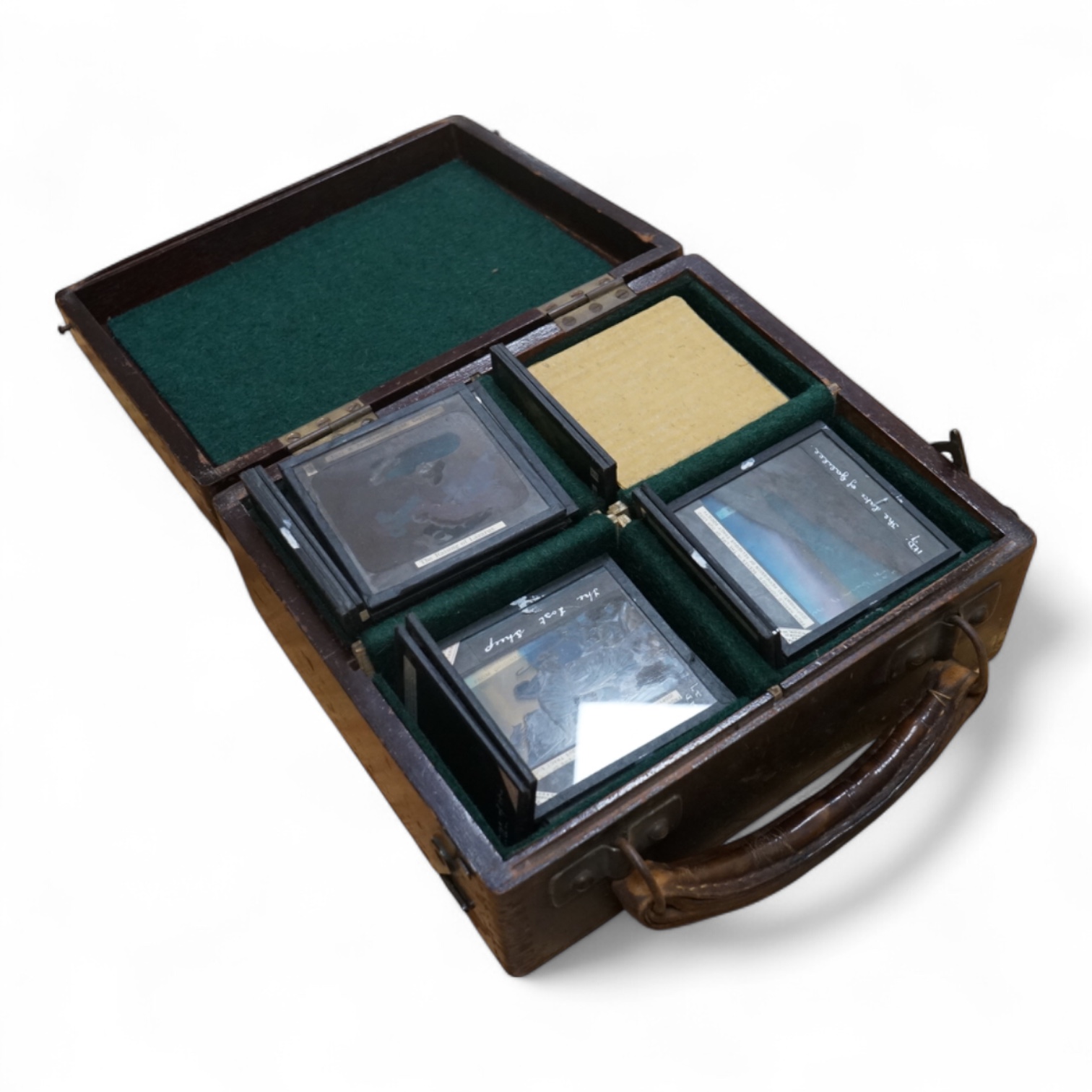 A tinplate and brass magic lantern, converted to an electric lamp and missing the original chimney, in a tin case, together with a case of slides, mostly biblical related.